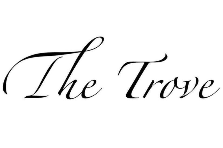 Logo of The Trove displaying the venue’s name in large flowing black script across a simple white background.