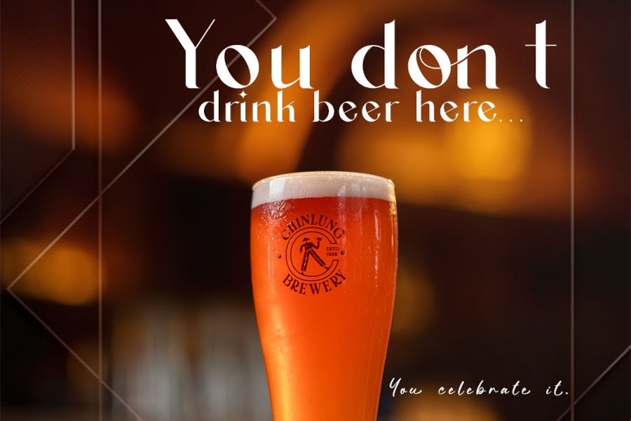 Tall glass of beer with Chin Lung logo, with the quote “You don’t drink beer here… You celebrate it”.