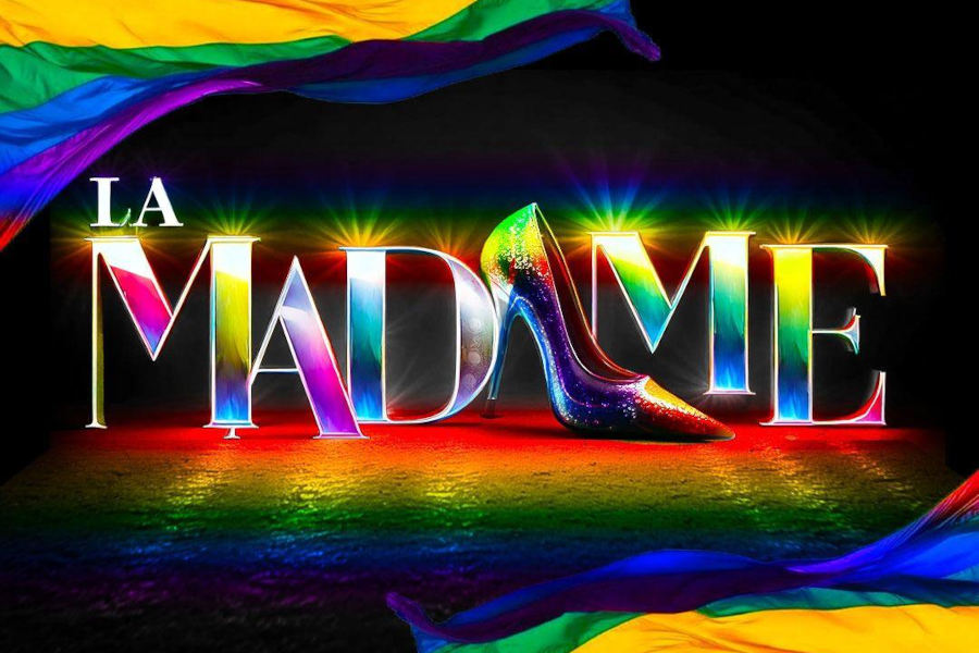 Logo de La Madame de León con temática de arcoíris que muestra elementos de la bandera del orgullo sobre un fondo negro.