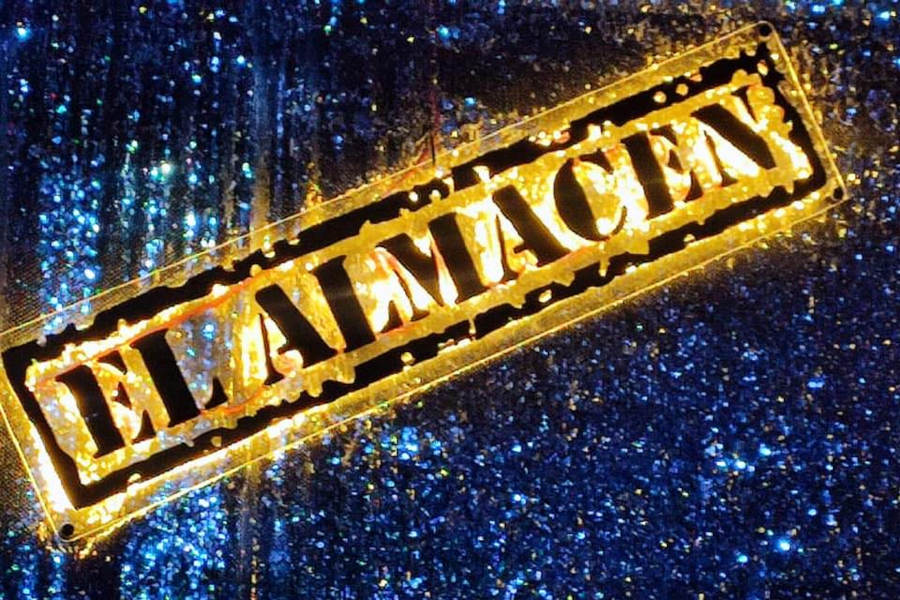 Logo de El Almacen bar con tipografía en dorado colocado sobre un fondo azul con textura.