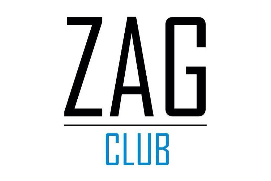 โลโก้ Zag Club ภูเก็ต ที่มีตัวอักษร “ZAG” สีดำขนาดใหญ่ อยู่เหนือคำว่า “Club” สีฟ้าขนาดเล็ก