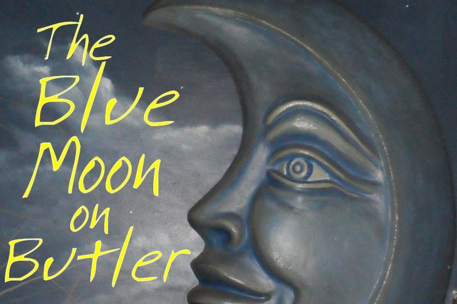 Stylized mural of a smiling moon with text “The Blue Moon on Butler”,