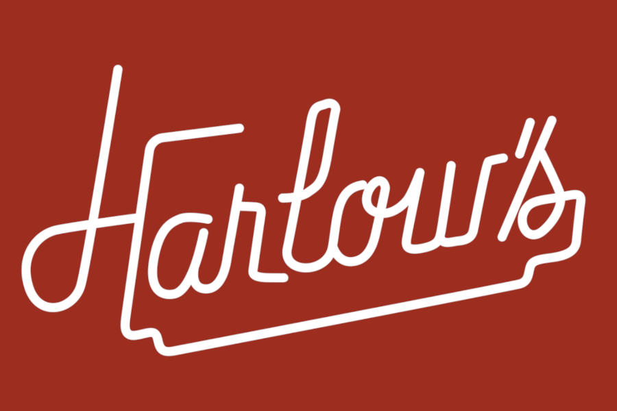 Logo of Harlow’s with flowing white script and an extended underline set against a dark red background.