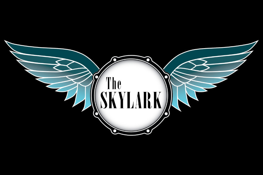 Black-background logo for The Skylark displaying a central drum design framed by large blue gradient wings.