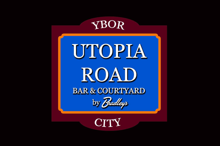 Logo of Utopia Road featuring a blue rectangular sign with white text, orange trim and a burgundy Ybor City frame.
