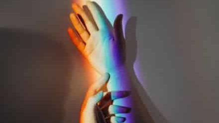 hands with a rainbow